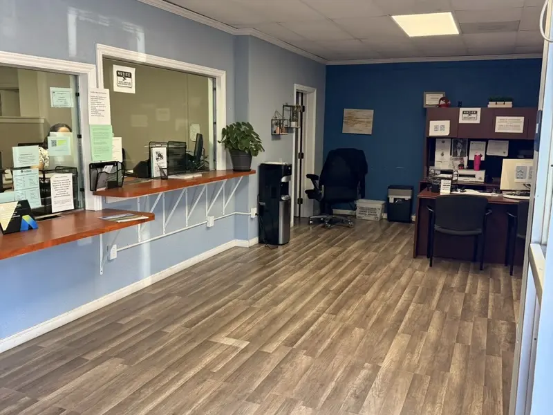 Inside the San Rafael office at 9 Vivian Street — service counter windows and an agent desk