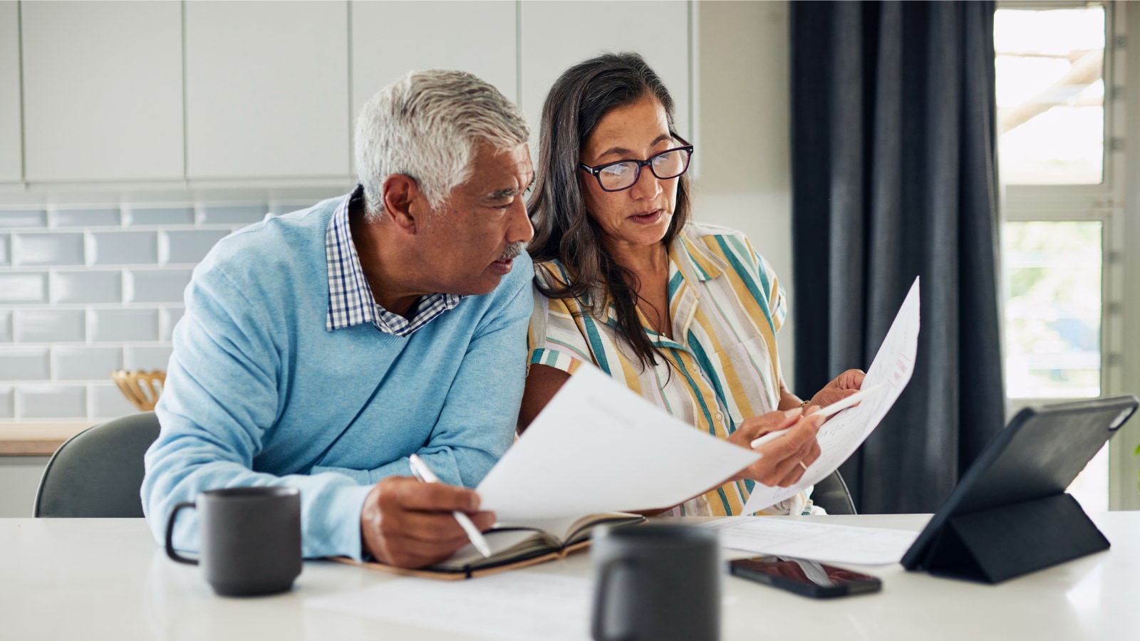 Older couple comparing insurance options